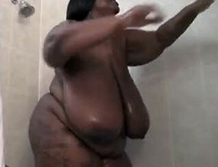 This hefty ebony gal drains in the shower. Her hefty ebony